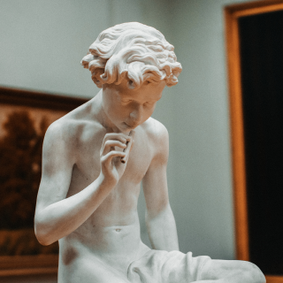 A statue of a person pondering over something